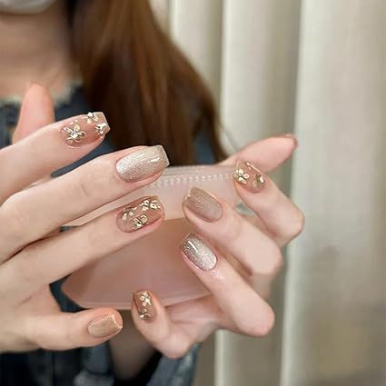 Add a touch of elegance to your nail game with these LANOVA Jelly Pink Middle Coffin Nails! Featuring stunning golden flower rhinestones and a champagne shimmer cat-eye effect, this set of 10 purely handmade press-on nails is customizable for the perfect fit. Shine bright and make a statement wherever you go! #PressOnNails #NailArt #HandmadeNails #GlamNails #NailDesign Pink Coffin Nails, Pink Coffin, Nails For Women, Cat Eye Nails, Golden Flower, Glam Nails, Rhinestone Designs, Nail Games, Silver Glitter