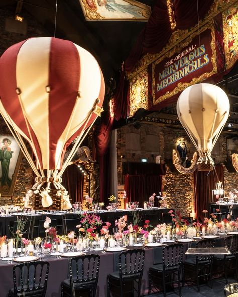 Step into a world of wonder with this whimsical, circus-themed wedding reception. Vibrant floral centerpieces decorate the tables, while giant hot air balloons float above, creating a playful and imaginative atmosphere. Perfect for couples looking for a unique and fun wedding reception idea. circus-themed wedding, whimsical reception, hot air balloons, floral centerpieces, unique wedding ideas, themed wedding, fun wedding decor, creative wedding inspiration. Jazzy Wedding, Whimsical Reception, Whimsical Circus, Fun Wedding Reception, Cirque Vintage, Casino Wedding, Circus Wedding, Fun Wedding Decor, Wedding Reception Fun