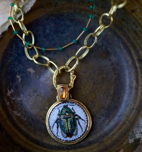 A stunning relic from another time. This 18th-century mosaic scarab pendant, adorned with a glowing rose cut yellow sapphire, set in 18K gold with an oxidized silver back and delicate gold details, feels like a treasure lost to history, now found. A symbol of transformation and endurance. Shown here with a delicate emerald necklace and a small medium chain, each sold separately. #scarab #scarabjewelry #ancientegyptianjewelry #relic #18kgoldjewelry #goldsmith #luxejewelry #luxurylifestyle #hi... Glowing Rose, Scarab Pendant, Ancient Egyptian Jewelry, Luxe Jewelry, 18k Gold Jewelry, Emerald Necklace, Oxidized Silver, Yellow Sapphire, Gold Details