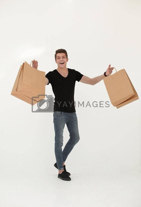 Smiling young man carrying shopping bags #Ad , #Sponsored, #man, #carrying, #shopping, #bags Walking Poses, Carrying Boxes, Yay Images, Model Release, Video Footage, Shopping Bags, Carry On Bag, Free Stock Photos, Carry On