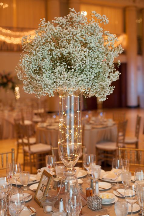 Voluminous baby's breathe and fairy lights add a magical touch for Jesse and James at DuPont Country Club. Amy Tucker Photography. Fairly Light Centerpiece, Fairy Lights Flower Centerpiece, Wedding Centerpieces Diy Fairy Lights, Center Piece For Prom, Wedding Table Decorations For Round Tables, Wedding Centerpiece With Fairy Lights, Table Decor For Quinceanera, Twinkly Lights Wedding Centerpiece, Fairy Lights In Vases Centerpieces