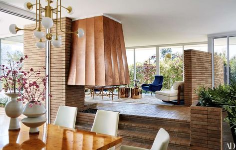 Below the front-room fireplace retains its original copper hood (now restored). - Architectural Digest Moore House, 1950s House, Mandy Moore, Graphic Design Studio, House Renovation, Celebrity Houses, Mid Century Modern House, Mid Century House, Office Interior Design