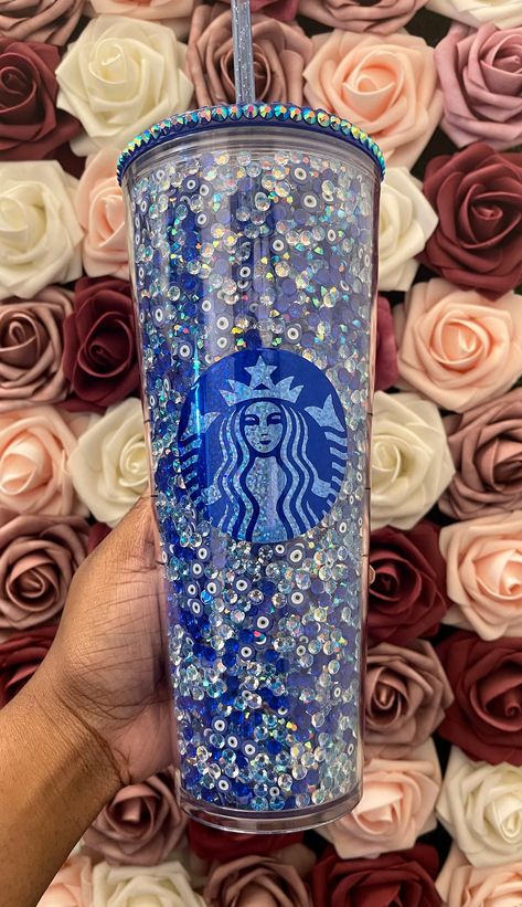 Starbucks Blue Evil Eye Rhinestone Filled Tumbler|Rhinestone Lid| Reverse Rhinestones|Lt. Sapphire AB New rhinestone filled tumblers! This tumbler is perfect for a bougie friend or yourself :) It shines to bright in the sun and gives off a very class look. This tumbler matches any aesthetic and is an amazing statement piece that all your friend will be talking about :) Hi there:) Starbucks is having a shortage of the 24 oz Acrylic tumblers but I have amazing Non Branded 24 oz tumblers that are t Starbucks Rhinestone Tumbler, Rhinestone Snowglobe Tumbler, Filled Tumblers, Copo Starbucks, Starbucks Cup Design, Starbucks Cup Art, Bling Bottles, Bling Tumbler, Bling Ideas