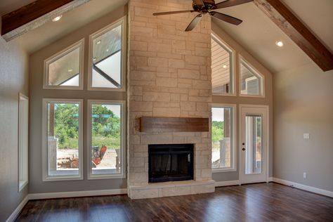 Cathedral ceiling with limestone fireplace. Fireplace With Opening On Each Side, Fireplace With Windows On Each Side Vaulted Ceilings, Fireplace In Cathedral Ceiling, Vaulted Ceiling Living Room Addition, House Plans With Cathedral Ceilings, Cathedral Ceiling With Fireplace, Cathedral Ceiling Lighting Ideas, Fireplace On Vaulted Ceiling Wall, Fireplace With Cathedral Ceiling