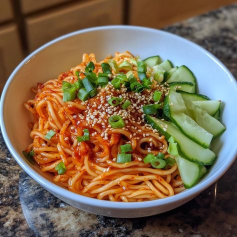 🍜 "Cool off with Korean Spicy Noodles—refreshing, tangy, and perfectly spicy for an unforgettable meal!" 🍜🔥 #BibimGuksu #SpicyNoodles Korean Spicy Noodles (Bibim Guksu) Ingredients: Cooked noodles (8 oz) Gochujang (2 tbsp) Soy sauce (2 tbsp) Honey (1 tbsp) Rice vinegar (1 tbsp) Cucumber (1/2 cup, julienned) Carrot (1/2 cup, julienned) Sesame seeds (1 tbsp) Green onions (for garnish) Instructions: In a bowl, mix gochujang, soy sauce, honey, and rice vinegar. Toss cooked noodles with the sa... Korean Spicy Noodles, Bibim Guksu, Julienned Carrots, Instagram Recipes, Spicy Noodles, Trending Recipes, Rice Vinegar, Sesame Seeds, Green Onions