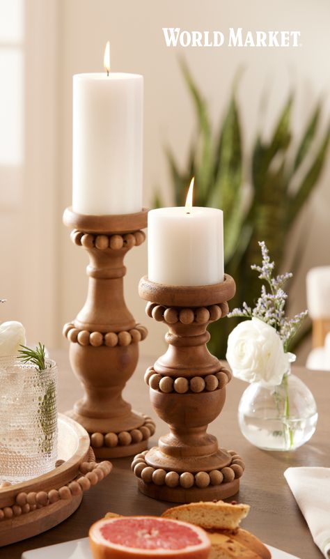 With its natural finish and charming ornate beading, these wood pillar candle holder have an understated festive look typical of chic, less-is-more Scandi design. Meticulously handcrafted, they are available in two sizes and embellishes any mantel or table with the warm touch and simple beauty of natural wood. #WorldMarket #Easter #EasterEntertaining #EasterDecor Rattan Candle Holder, Coaching Pictures, Boho Candle Holders, Beaded Candle Holders, Wood Pillar Candle Holders, Outdoor Candle Holders, Boho Candle, Easter Entertaining, Beaded Candle