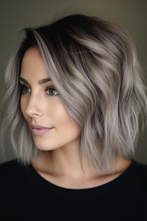 Ash blonde with bold black streaks is a dramatic and contemporary style. The black streaks create a stark contrast against the ash blonde base, offering a bold and unique look.  Click here to check out more trending ash blonde hair color ideas you need to try.