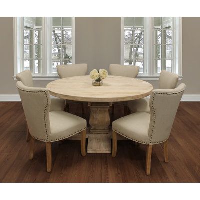 This 6-person dining set ties together traditional craftsmanship with an elegant modern twist. It includes one 58" round solid wood dining table, and 6 purple linen upholstered side chairs. This table is finished in a hand-distressed white wash to bring out the natural wood grain variation. Each chair features solid wood legs and nailhead trim for a touch of class. Chair Color: Cream/Beige | MOTI Furniture 6 - Person Mango Solid Wood Dining Set Wood / Upholstered Chairs in Brown / Indigo / White Cream Dining Room, White Dining Room Sets, Oval Dining Room Table, Kitchen Table And Chairs, Farmhouse Dining Set, Breakfast Nook Dining Set, Round Dining Room Sets, Round Table And Chairs, Nook Dining Set