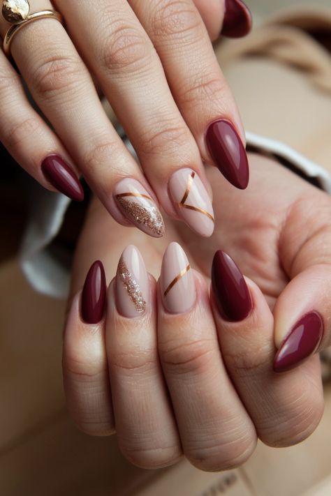 Dive into the essence of autumn with these stunning acrylic fall nail ideas that capture the warmth of the season! Imagine a rich burgundy base adorned with delicate gold leaf accents, perfectly encapsulating the cozy feel of fall. These nails not only elevate your style but also let you express your love for this vibrant time of year. Get inspired and transform your nails for the season! Fall Nails Gold Accent, Winter Burgundy Nails, November Nails Ideas Almond, Burgundy Fall Nails Designs, Fall Bridesmaid Nails, Burgundy Winter Nails, Burgundy Nails With Gold, Burgendy Nails, Nailart Simple