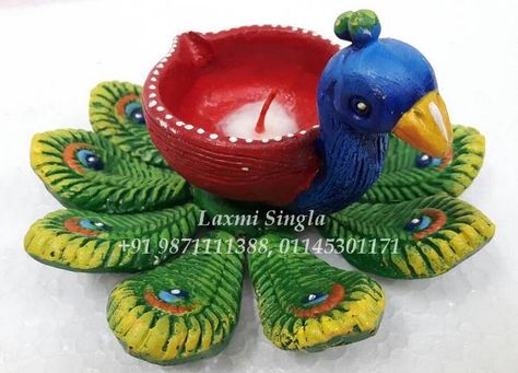 Peacock design with Diya made up by Terracotta Clay Art enhanced with attractive colours. Diya Decoration Ideas With Clay, Diwali Clay Art, Peacock Diya Decoration, Diwali Clay Craft, Clay Diya Decoration Ideas Creative, Terracotta Clay Ideas, Clay Diyas For Diwali, Clay Peacock, Clay Diya