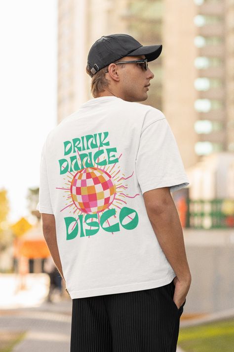 "Step onto the dance floor in style with our \"Drink Dance Disco\" t-shirt - the ultimate choice for those who want to groove with a touch of retro charm! 💃✨ Front: Left Pocket design Back: Full Back design Disco dance party shirt \"Drink Dance Disco\" tee Retro vibes slogan t-shirt 70s-themed dance top Disco fever apparel Fun party dance shirt Groovy nightlife tee Disco ball graphic shirt Vintage disco slogan top Celebration dancewear Music and dance t-shirt Retro disco party apparel Drink and Vintage Disco Tshirt, 70s T Shirts Vintage Tees, Retro T Shirt Designs, Retro Disco Party, Music Shirt Design, Disco Dance Party, Dance T Shirt, Vintage Disco, Dance Shirt