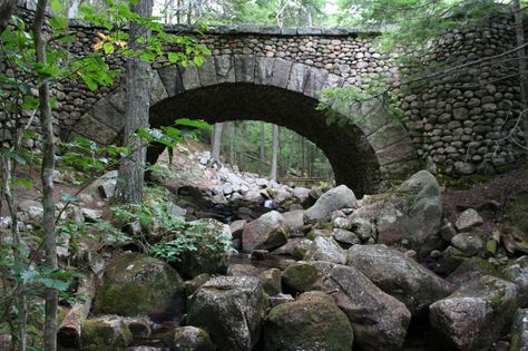 Designed by John D. Rockefeller Jr. in Acadia National Park in Maine, the Cobblestone Bridge was built in 1917 and spans Jordan Stream. Cobblestone Bridge, Linear Park, Maine Vacation, Arch Bridge, Stone Arch, Stone Bridge, Road Trip Hacks, Acadia National Park, Historic Preservation