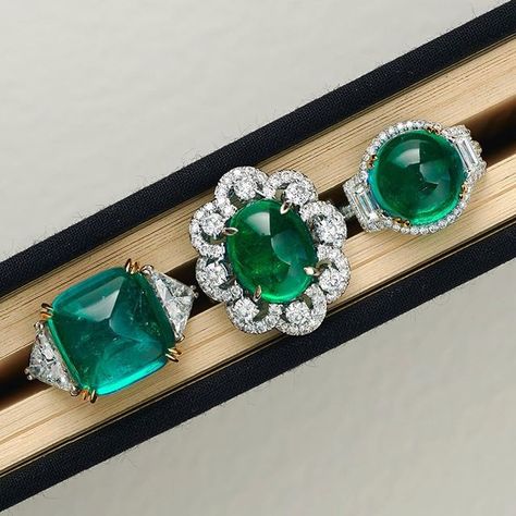 Three mysteries in one book. From left to right, or from West to East, a Colombian cabochon emerald ring, 14.16 carats, set with 3.03 carats of diamonds; a Zambian emerald ring, 7.56 carats, set with 1.84 carats of daimonds; and a vivid green Colombian round cabochon emerald ring, 7.49 carats, set with 1.37 carats of diamonds. #chatila #chatilajewels #emeralds #cabochonemerald Cabochon Emerald Ring, Gems Rings, Gem Rings, Elegant Rings, Emerald Cabochon, Golden Rings, Big Stone Ring, Emerald Rings, High Jewellery