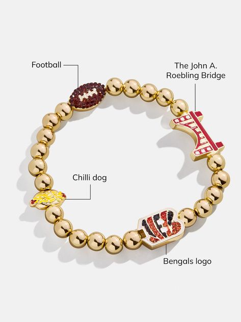 The Cincinnati Bengals NFL Charm Bracelet is the ultimate accessory for die-hard football fans. This bracelet celebrates the team with spirited motifs, including the Bengals logo, the John A. Roebling Bridge, a chili dog, and a football. Perfect for game days or everyday wear, this bracelet adds a touch of sports-inspired elegance to any outfit. This bracelet features 6mm gold ball beads. This is an officially licensed NFL product. Cincinnati Bengals Outfit Woman, Bengals Game Day Outfit, Bengals Outfit, Bengals Logo, Chili Dog, Beaded Charm Bracelet, Game Day Outfit, Gifts For, Birthday Wish List