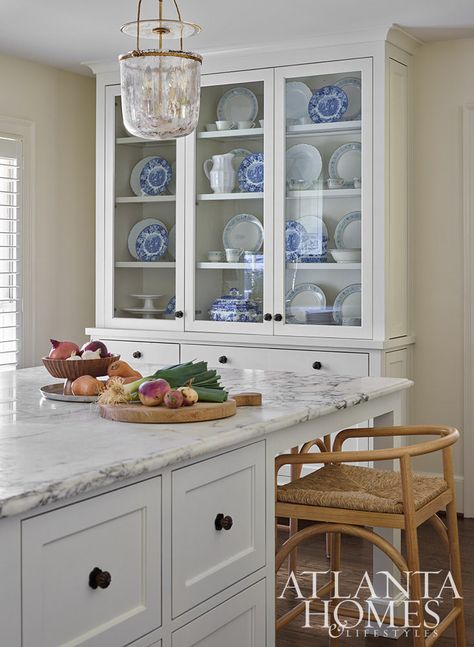 Barstools from Ballard Designs sidle up to Carrara marble countertops in the kitchen. The pendant lights are Visual Comfort & Co. and the hardware is Rocky Mountain Hardware. Carrara Marble Kitchen, Marble Kitchen, Atlanta Homes, Ranch Style Home, Kitchen Marble, Color Depth, Kitchen Countertop, Historic Home, Ballard Designs