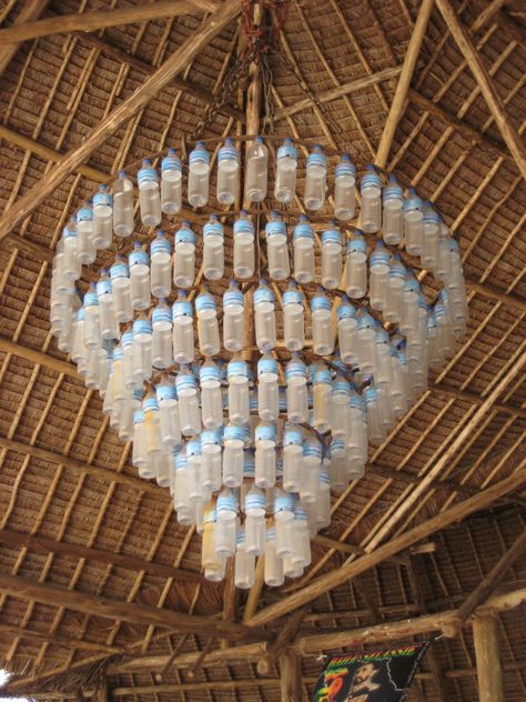 Logan's Project on Pinterest | Plastic Bottles, Chandeliers and ... Plastic Bottle Chandelier, Plastic Chandelier, Plastic Bottle Tops, Bottle Chandelier, Recycle Design, Recycled House, Flower Bed Designs, Plastic Bottle Art, Flower Bedding