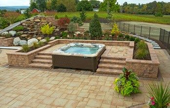 Spa Retreat: Integrate a hot tub into your Hardscape | EP Henry Hot Tub Landscaping, Tub Deck, Hot Tub Surround, Hot Tub Patio, Outdoor Living Space Design, Wall Design Ideas, Sloped Yard, Hot Tub Deck, Hot Tub Backyard