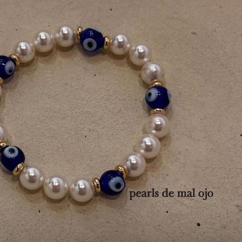 "pearls de mal ojo" this unisex bracelet is made out of blue glass evil eyes from turkey and swarovski pearls the stretchy material makes it perfect for all wrist sizes each order comes with a 12:15 jewelry bag Bracelet Ideas Evil Eye, Evil Eye Beaded Bracelet, Simple Beaded Bracelets, 15 Jewelry, Evil Eye Beads, Clay Bracelet, Evil Eyes, Eye Beads, Bracelet Ideas