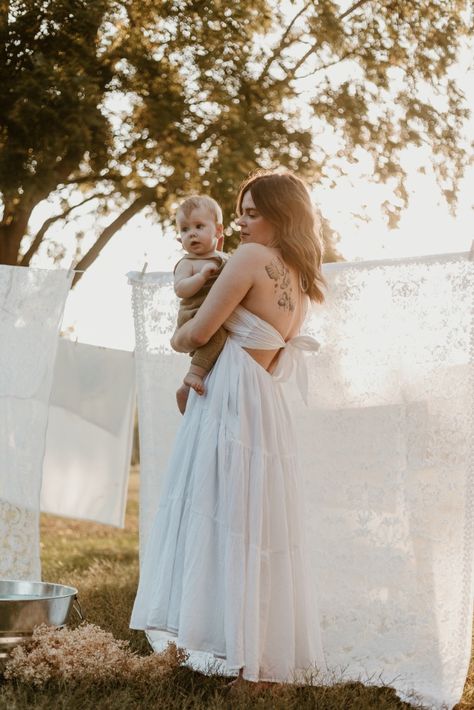 This photoshoot in Fort Calhoun, NE. (Omaha, NE and surrounding areas) captures motherhood and childhood with a simple backdrop of white linens. Taken place on a private farm featuring hand picked apples, pumpkins and baby-breath. A family session and mommy and me session that we will never forget! #mommyandme Sheet Backdrop Family Photoshoot, Clothesline Mini Session, Clothes Line Photoshoot Mommy And Me, Mothers Day Mini Session Ideas Outdoor, Mother’s Day Mini Session, Clothes Line Photoshoot, Clothesline Photoshoot, Laundry Photoshoot, Gifts Made With Cricut