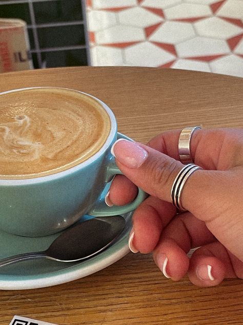 I am holding a green cup of cappuccino. I'm wearing silver rings and you can see my French nail tip manicure with thin French nails. Coffee And Nails Aesthetic, French Nails Silver, Minimalist Nails Neutral, Coffee And Nails, Nails Minimalist, Nails Neutral, Night Coffee, Barista Coffee, Nails Silver