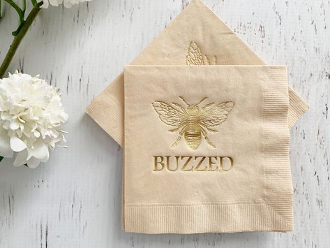 "Those Bees Knees cocktails will look even more inviting when served on the BUZzED Honey Bee Beverage Napkins. These 2-ply cocktail napkins measure 5\" and feature an abstract honeycomb pattern and bee with a white and gold theme. Set of 16 napkins, each 4.75x4.75 inches.  Matching dessert size also available, as well as matching cups and lots more napkins. Complete your whole party with EnFete - everything from balloon arches, to cups and plates - everything you need to put together a perfectly Bee Wedding Theme, Bees Knees Cocktail, Cups And Plates, Bee Wedding, Tea Party Table, Balloon Arches, Wedding Photo Props, Gold Theme, Bee Baby Shower