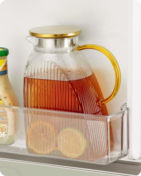 PRICES MAY VARY. Compact yet spacious - This approximately half-gallon beverage pitcher is designed with a slim profile, measuring just 9.5cm in width, allowing it to fit into most refrigerator doors and freeing up extra storage space. The body of this glass water pitcher features vertical stripe patterns, while the glass handle is golden and the lid is adorned with a golden electroplated finish, adding a touch of elegance to its minimalist look. Heat & cold resistant - Made of high borosilicate glass, this fridge water pitcher offers greater resistance to temperature changes compared to regular ones. This high-quality glass carafe pitcher can withstand temperatures as low as -10°C/14°F and as high as 110°C/230°F, making it suitable for both refrigeration and heating on a ceramic hob or ov Refrigerator Doors, Glass Water Jug, Fridge Door, Homemade Drinks, Body Features, Glass Jug, Glass Carafe, Water Pitcher, Water Pitchers