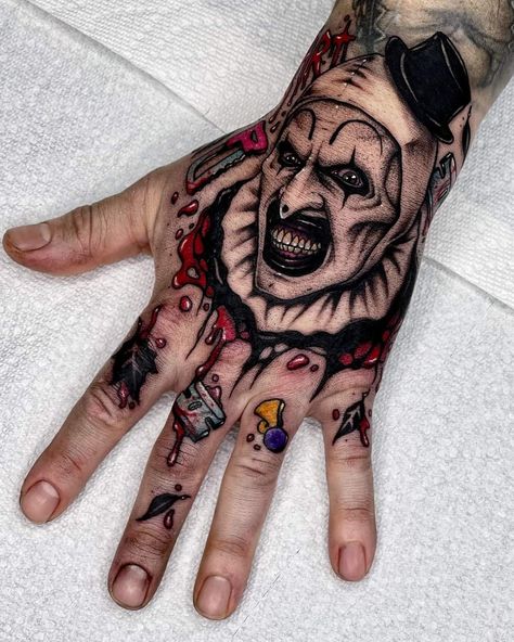 Hand Tattoos Horror, Wrist Forearm Tattoo Men, Horror Movie Hand Tattoos, Michael Myers Hand Tattoo, Terrifier Tattoo Ideas, Pennywise Hand Tattoo, Skull On Hand Tattoo Design, Cartoon Horror Tattoos, Ghostface Hand Tattoo