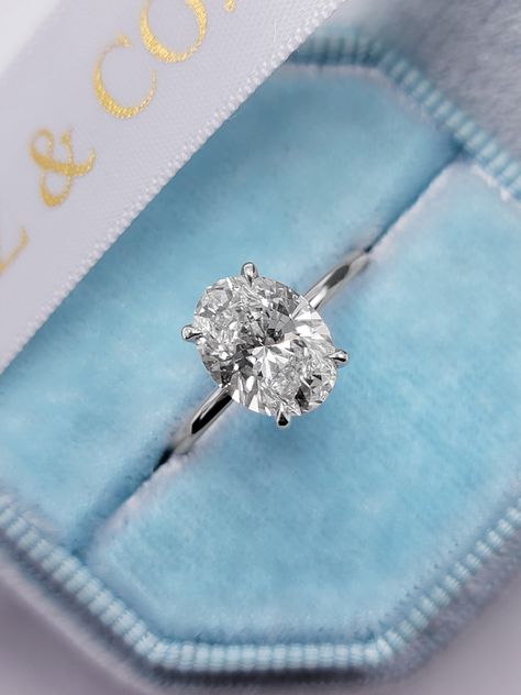 This astonishing 2.25 carats ring has a 2.07 carat lab grown oval cut center diamond and is IGI certified at "E" in color and "VS1" in clarity, (Excellent Cut, Polish and Symmetry) and is set in a classy solitaire setting with a hidden halo, all in 14k white gold. The ring can also be made in yellow/rose gold or platin Wedding Band For Women, Future Engagement Rings, Sterling Silver Promise Rings, Solitaire Setting, Oval Engagement, Simple Engagement Rings, Ring Wedding Band, Dream Engagement Rings, Silver Wedding Rings