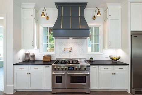 Stunning cooktop designed with a black French wood range hood accented with brass trim. Metal Range Hood, Wood Range Hood, Stainless Steel Hood, Custom Range Hood, Kitchen Hoods, Transitional Kitchen, Kitchen Inspiration Design, Farmhouse Style House, Range Hood