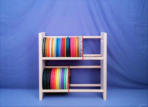 "These hand-made disc golf racks are perfect for organizing untamed heaps of plastic. They are built to order (with customization available) and are shipped for free to the US! Storage possibilities are anywhere from 15 discs all the way up to over 240 discs, depending on the size chosen.  This listing includes 2-level racks only, please check out my shop for more size variations! Design:  All racks have beveled edges to ensure comfort when touching or moving the racks. They are built with 1\" t Disc Golf Storage, Golf Storage, Diy Storage Rack, Frisbee Golf, Reno Nv, Diy Holder, Disc Golf, Diy Shelves, All The Way Up