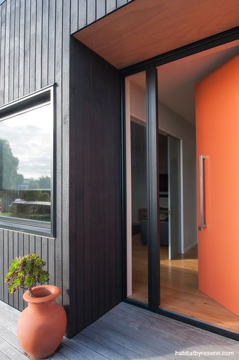 house exterior, black house, orange front door, black exterior, orange and black, black cladding Black Shutters Interior, Orange Front Door, Front Door Black, Black Cladding, Orange Front Doors, Metal Doors Exterior, Rustic Front Door, Mid Century Modern Exterior, Orange Door