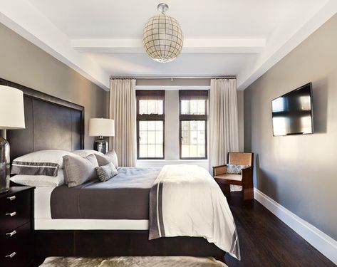 Silvery shades of gray make this master bedroom shimmer with natural lighting and radiate with masculinity.Photo by Joshua Smith Inc Dark Brown Floor, Light Gray Bedroom, Beige Headboard, Dark Wood Bed, Brown Floor, Grey Wood Floors, Beige Curtains, Gray Walls, Beige Bedroom