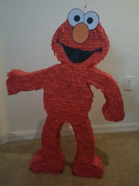 Elmo's piñata Sesame Street Pinata Ideas, Elmo Pinata Diy, Elmo Pinata Number 2, Elmo Pinata, Aesthetic Elmo Party, Elmo’s World Birthday Theme, Elmo’s World Birthday Invitation, Sesame Street Birthday Party Ideas Boy, Baby Elmo