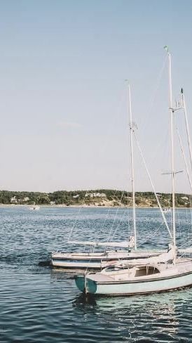 two boats sitting in the blue ocean with a greenery background and foggy sky Sailboats, Cape Cod, Cape, Water, Blue, Art