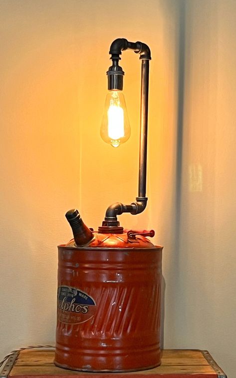 Medium sized industrial accent lamp made from an old gas can and pipes. The spout cap is the switch. Made using new, high quality electrical components. Edison bulb included. Gas Can Repurposed, Spray Can Lamps, Gas Can Christmas Tree, Soup Can Lamp, Intake Manifold Lamp, Gas Nozzle Lamp, Vintage Gas Cans Repurposed, Old Fire Extinguisher Lamps, Steam Punk Lamp