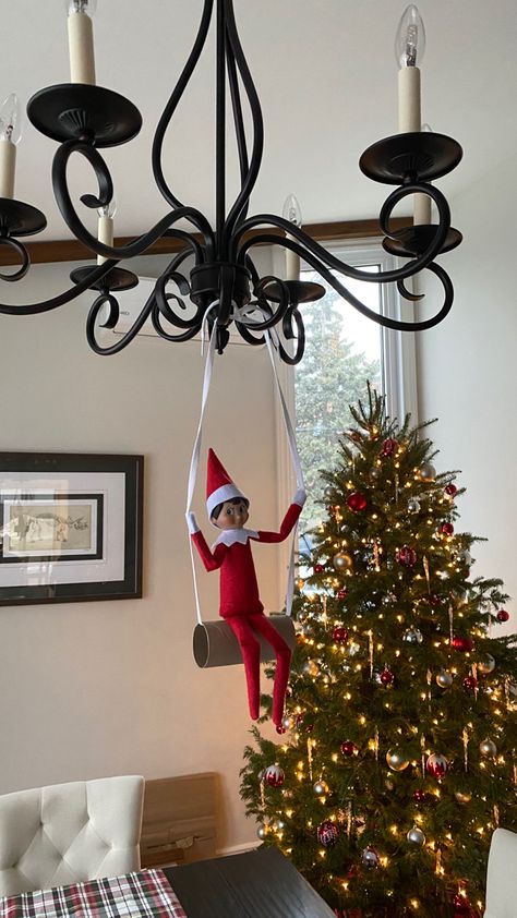 Elf on the shelf is swinging on a toilet paper roll hanging from a chandelier. Easy Design, Toilet Paper Roll, Paper Roll, On The Shelf, Design Tips, Elf On The Shelf, Toilet Paper, Simple Designs, Elf