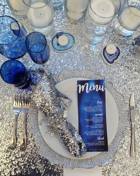 Sweetheart Table Details. This Place Setting Displays Silver Sequin Tablecloth & Napkins, Silver Reef Charger Plate, Silver Gem Napkin Ring, Custom Blue Agate Wedding Dinner Menus, Blue Agate Candle Holders, Blue Glassware And Floating Candles Snowflake Dinner Party, Blue And Silver Dinner Table Setting, Blue Silver Table Decor, Blue And Silver Event Decor, Blue White Silver Birthday Decorations, Blue Silver Christmas Table, Blue Birthday Dinner Decor, Blue And Silver Table Decorations, Blue And Silver Table Decor