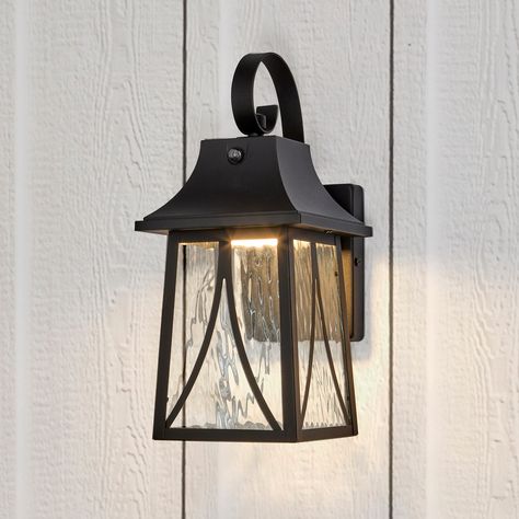 This decorative LED outdoor wall light is a porch lantern fixture with a metal black frame and a clear water glass lens. This traditional wall light features a photocell sensor, also known as a dusk-to-dawn sensor, which can turn your light on and off automatically. This is a great added convenience, allowing you to keep your home safe and well-lit without having to turn the outdoor light on and off manually each day. This vintage style light produces 900 lumens of 3000K warm white light and con Outside Lights On House, Farmhouse Outdoor Lighting, Porch Lantern, Outdoor Wall Light Fixtures, Coach Lights, Black Outdoor Wall Lights, Led Outdoor Wall Lights, Warm White Light, Led Outdoor Lighting