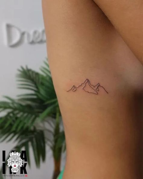 Discover 100+ minimalist tattoo ideas with meaning. Explore tattoo designs from minimalist animal tattoos, to geometric shapes, text-based ink, and more. Explore the art of minimalism today. Meaningful Mountain Tattoos, Mountain Tattoo Women Arm, Long Mountain Tattoo, Lake Louise Tattoo, Accountability Tattoo, Minimalist Outdoor Tattoo, Nature Tattoos Minimalist, Patagonia Tattoo Ideas, Run Tattoo For Women