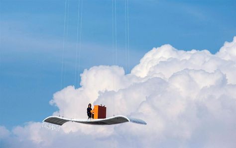 Image: German pianist Stefan Aaron plays an orange piano on a 'flying carpet' platform suspended from a helicopter, over the Munich airport Orange Piano, Munich Airport, Sound Sculpture, Sculpture Museum, Flying Carpet, Malaysia Airlines, Playing Piano, Above The Clouds, Magic Carpet