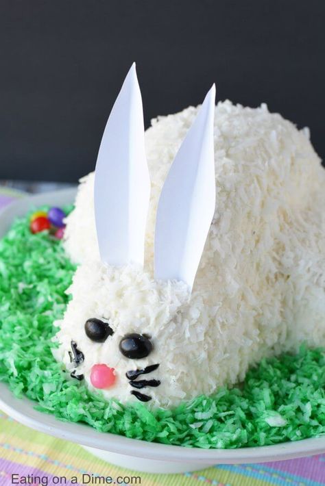 This adorable Easter Bunny Cake will be a hit! You will love how simple this easy bunny cake is. The flaky coconut and jelly beans come together to make this bunny cake recipe so cute! Try this Easter cake recipe! We love easy Easter cakes!  #eastercakes #easterdesserts #easterbunny #easter #eatingonadime #easterdessert #easterrecipes #easterkids Basket Cupcakes, Easter Dirt Cake, Easter Basket Cupcakes, Easter Cake Easy, Baking Holiday, Easter Egg Cake, Easter Dinner Table, Easter Cake Recipes, Nursing Cake