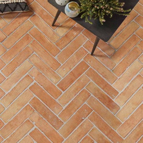 Sold by the m2 Requires sealing Ca' Pietra Marlborough Parquet Terracotta Floor Tile 7.5x30.5cm. Terracotta tiles with a handmade finish. Transform your space into a rich russet oasis of yesteryear with these terracotta parquet floor tiles. Also available as arabesque tiles and hexagon tiles. Terracotta floor tiles Ca' Pietra presents the Marlborough range. With these terracotta tiles, nostalgic red and orange pigments are revisited and redesigned for the modern and hardworking home. Take yourself to terracotta floor tiles heaven with this classic choice, sure to stun as kitchen floor tiles, hallway tiles and living room flooring, while emulating country cottage chic. Brick effect tiles But the rustic tiles appeal doesn't stop there; lay these crafted clay brick beauties in a herringbone t Terracotta Terrace Floor, Brick Floor Kitchen Farmhouse Style, Terracota Tiles Floor Modern, Terracotta Tiles Living Room, Terracotta Parquet, Floor Tiles Hallway, Terracotta Bathroom Tiles, Clay Tile Floor, Herringbone Floor Tiles