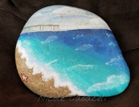 Beach pier Ocean painted rock #52rocks #paintedrocks #kindnessrocks Ocean Themed Painted Rocks, Beach Rock Painting Ideas, Beach Rock Painting, Rock Painting Supplies, Painted Pictures, Dolphin Painting, Rock Designs, Rock Painting Tutorial, Diy Rock Art