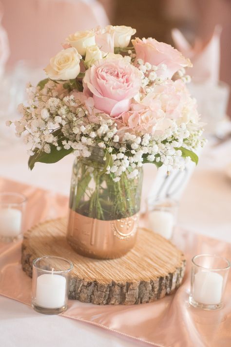 Rose and hydrangea centerpiece with painted mason jar and wood round Mason Jar Centerpieces For Quinceaneras, Wedding Wood Round Centerpiece, Simple Flower Vase Centerpiece, Centerpieces With Wood Rounds, Simple Quince Centerpieces, Simple Quinceanera Ideas, Centerpieces With Wood, Baby Shower Floral Centerpieces, Wedding Table Centerpieces Diy