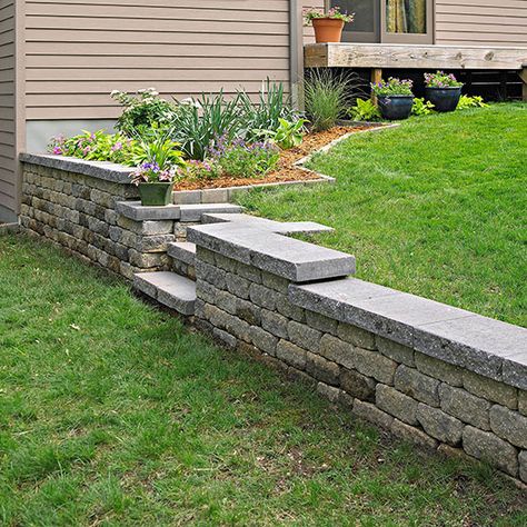 Build a Retaining Wall Conquer a problem slope by installing a concrete-block retaining wall -- you'll add space, structure, and value to your backyard. Retaining Wall With Steps, Concrete Block Retaining Wall, Diy Retaining Wall, Backyard Retaining Walls, Retaining Wall Blocks, Building A Retaining Wall, Concrete Retaining Walls, Sloped Yard, Concrete Patios