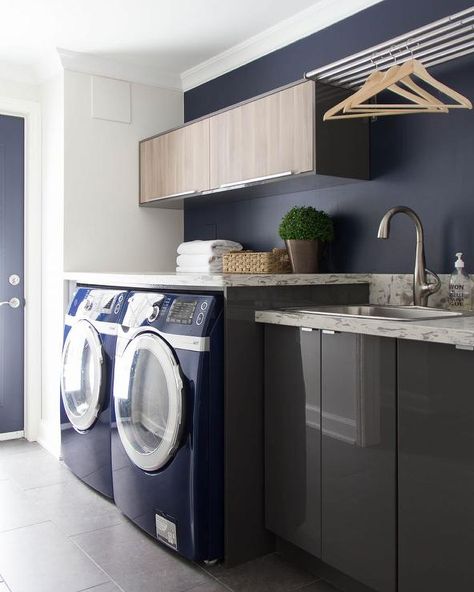 Contemporary laundry room features gray lacquered cabinets by Ikea topped with gray and white quartz countertops which resemble marble fitted with a stainless steel sink and satin nickel faucet tucked under a 6 drying rods. Cabinets Above Washer And Dryer, Ikea Laundry Room Cabinets, Laundry Room Modern, Laundry Room Stackable, Ikea Laundry, Contemporary Laundry Room, Ikea Laundry Room, Vintage Laundry Room Decor, Laundry Room Countertop