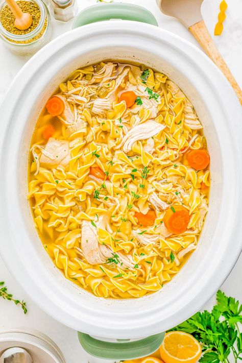 Slow Cooker Chicken Noodle Soup - Classic and comforting chicken noodle soup with loads of juicy chicken, tender noodles, carrots, celery, and seasoned to perfection so that it tastes just like grandma used to make it! But this recipe is made with EASE and convenience in mind by using your Crock-Pot. Just add the ingredients, set it and forget it, and your soup will taste AMAZING! Comforting Chicken Noodle Soup, Slow Cooker Chicken Noodle, Slow Cooker Chicken Noodle Soup, Chicken Noodle Soup Crock Pot, Creamy Chicken Noodle Soup, Averie Cooks, Leftovers Soup, Chicken Tender, Carrots Celery