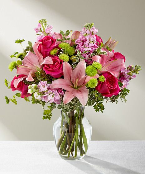 Pink Posh Bouquet is chic and pink to help you celebrate life's most treasured moments in style! Hot pink roses are bright and beautiful arranged amongst pink Asiatic Lilies, pink stock, and lush greens to create that perfect gift of flowers. Presented in a clear glass vase, this blushing fresh flower arrangement is ready to send your sweetest wishes in honor of a birthday, an anniversary, or as a way to express your thanks and gratitude. Tall Pink Floral Arrangements, Bupleurum Bouquet, Gilly Flower, Flower Arrangements In Vase, Birthday Flower Arrangements, Birthday Arrangements, Pink Flower Vase, Bouquet In Vase, Flower Arrangement Vase