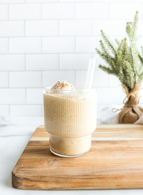 A vegan eggnog recipe transformed into a protein smoothie. This incredibly rich and creamy Eggnog Smoothie recipe tastes like the real deal, but is blended in minutes using wholesome plant-based ingredients. Created with frozen banana, medjool dates, vanilla plant protein, raw cashews, coconut milk, and holiday spices. It’s full of festive flavors, while being packed with nutrients, making it the perfect Christmas smoothie. Eggnog Smoothie, Christmas Smoothie, Vegan Eggnog Recipe, Holiday Smoothies, Vegan Beverages, Christmas Smoothies, Vegan Eggnog, Creamy Eggnog, Smoothie Recipes With Yogurt