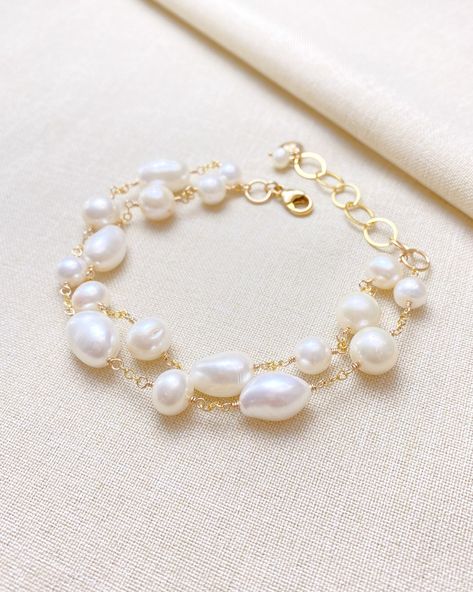 Make a classic and elegant statement with this multi-layered mixed pearl bracelet. Two handcrafted strands of differently shaped and sized pearls create a versatile accessory suitable for weddings, brunches, work, and more. The lobster clasp and extender ensure a secure and adjustable fit. Length: 7.5 inches plus 1.5 inch extender Materials: gold fill, cultured freshwater pearls Gift box included. Bracelet Clasps Ideas, Journal Lettering, Pearl Bracelet Gold, Pearl Gifts, Pearls Diy, The Lobster, Silver Jewelry Necklace, Freshwater Pearl Bracelet, Freshwater Cultured Pearls